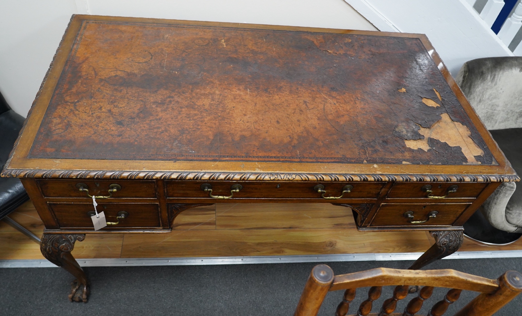 An early 20th century Chippendale Revival mahogany kneehole writing table, width 136cm, depth 75cm, height 76cm. Condition - fair, leather poor